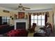 Cozy living room with a fireplace, ceiling fan, and comfortable seating at 259 Brassfield Dr, Burlington, NC 27217