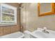 Bathroom with a shower-tub combo, sink, medicine cabinet and window at 2677 Nc-39, Henderson, NC 27537