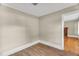 Cozy bedroom with neutral walls and laminate flooring adjacent to the living room area at 2677 Nc-39, Henderson, NC 27537