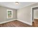 Bedroom with hardwood flooring, neutral walls, and bright window at 2677 Nc-39, Henderson, NC 27537