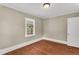 Bright bedroom featuring hardwood floors, neutral paint, and a window for natural light at 2677 Nc-39, Henderson, NC 27537