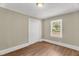 Bedroom with hardwood flooring, closet, and neutral-colored walls at 2677 Nc-39, Henderson, NC 27537
