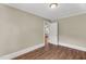 A bedroom with wood-look floors, light-colored walls, and a view into an adjacent room at 2677 Nc-39, Henderson, NC 27537