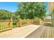Newly built wooden deck with railing, offering backyard views and outdoor space at 2677 Nc-39, Henderson, NC 27537