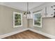 Cozy dining room featuring hardwood flooring, pendant lighting, and natural light at 2677 Nc-39, Henderson, NC 27537