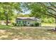 Inviting single-story home with a bright green exterior and well-manicured landscaping in a green setting at 2677 Nc-39, Henderson, NC 27537