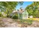 Cozy single-story home with a green exterior, a sunroom, and a storage shed at 2677 Nc-39, Henderson, NC 27537