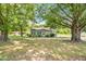 Charming, single-story home with a green exterior and mature trees in a tranquil setting at 2677 Nc-39, Henderson, NC 27537