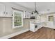 Functional kitchen with white cabinetry, hardwood flooring, and natural light at 2677 Nc-39, Henderson, NC 27537