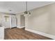 Kitchen with hardwood flooring, white appliances and cabinets, and bright light at 2677 Nc-39, Henderson, NC 27537