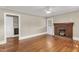 Inviting living room with hardwood floors, a brick fireplace, and a ceiling fan for added comfort at 2677 Nc-39, Henderson, NC 27537