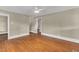 Open living room with hardwood floors, neutral paint, and access to other rooms in the home at 2677 Nc-39, Henderson, NC 27537