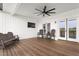 An outdoor space includes a ceiling fan, a TV, and outdoor seating with an amazing view at 2775 Eagles Roost Trl, Burlington, NC 27217