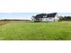 Large green backyard featuring a deck and wood fencing at 2775 Eagles Roost Trl, Burlington, NC 27217