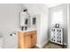 Bright bathroom features a wood vanity with black hardware and a decorative cabinet with a window above at 2775 Eagles Roost Trl, Burlington, NC 27217