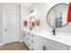 Bright bathroom features a double vanity with black hardware and round mirrors at 2775 Eagles Roost Trl, Burlington, NC 27217