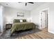 Serene primary bedroom with ceiling fan and wood floors offers a tranquil retreat at 2775 Eagles Roost Trl, Burlington, NC 27217