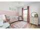 Lovely Bedroom showcases pink trim, a white crib, an egg chair, and natural light at 2775 Eagles Roost Trl, Burlington, NC 27217
