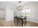 A dining room shows a table set with chairs and a modern light fixture at 2775 Eagles Roost Trl, Burlington, NC 27217