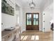Elegant foyer with hardwood floors, double glass doors, and stylish console table at 2775 Eagles Roost Trl, Burlington, NC 27217