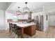 A kitchen features pendant lighting, an island with breakfast bar, stainless steel appliances, and wood flooring at 2775 Eagles Roost Trl, Burlington, NC 27217