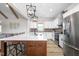 Kitchen with white cabinets, brick backsplash, stainless steel appliances and large island with seating at 2775 Eagles Roost Trl, Burlington, NC 27217