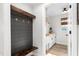 The mudroom features a wood bench, coat hooks, and adjacent laundry room at 2775 Eagles Roost Trl, Burlington, NC 27217