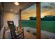 View from porch showcasing beautiful landscape and rocking chairs at 2775 Eagles Roost Trl, Burlington, NC 27217
