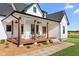 Inviting front porch features wood flooring, ceiling fans, and comfortable rocking chairs at 2775 Eagles Roost Trl, Burlington, NC 27217