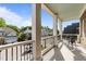 Spacious balcony with elegant columns, black iron railings, and a cozy seating area overlooking the neighborhood at 2820 Charleston Oaks Dr, Raleigh, NC 27614