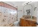 Well-lit bathroom featuring a stylish vanity with granite countertop and a charming shower curtain at 2820 Charleston Oaks Dr, Raleigh, NC 27614