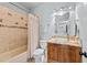 Cozy bathroom featuring light blue walls, a granite countertop sink, and a tiled shower at 2820 Charleston Oaks Dr, Raleigh, NC 27614