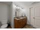 Bathroom featuring double sinks with granite countertops, offering ample space and a touch of elegance at 2820 Charleston Oaks Dr, Raleigh, NC 27614