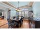 Formal dining room features elegant chandelier, wainscoting, and large window at 2820 Charleston Oaks Dr, Raleigh, NC 27614