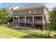 Large brick home with a covered back porch and well-manicured lawn at 2820 Charleston Oaks Dr, Raleigh, NC 27614