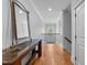 Second floor hallway with hardwood floors and a decorative console table at 2820 Charleston Oaks Dr, Raleigh, NC 27614