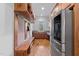 Mudroom features built in cubbies, a bench, stainless steel refrigerator and wooden cabinets at 2820 Charleston Oaks Dr, Raleigh, NC 27614
