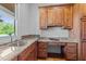 Office nook features a built in desk, drawers, overhead wooden cabinets and a granite countertop at 2820 Charleston Oaks Dr, Raleigh, NC 27614