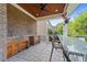 Covered outdoor bar offers a space for entertainment with granite countertop and sink at 2820 Charleston Oaks Dr, Raleigh, NC 27614