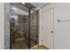Tiled shower with glass doors and modern fixtures in bathroom at 2820 Charleston Oaks Dr, Raleigh, NC 27614