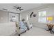 Relaxing sitting room with windows, ceiling fan, and comfortable seating area with access to bedroom at 2820 Charleston Oaks Dr, Raleigh, NC 27614