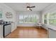 Bright sitting room featuring a ceiling fan, hardwood floors, and large windows with a beautiful view at 2820 Charleston Oaks Dr, Raleigh, NC 27614