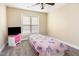 Bright bedroom with carpet flooring, a pink nightstand, and a whimsical pink quilt at 300 Sugar Maple Ave, Wake Forest, NC 27587