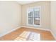 An empty bedroom with hardwood flooring and natural light from the window at 300 Sugar Maple Ave, Wake Forest, NC 27587