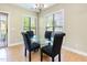 Cozy dining area with glass top table, chandelier and plenty of natural light at 300 Sugar Maple Ave, Wake Forest, NC 27587