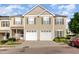 Charming townhome featuring two-car garage, green shutters, and well-maintained landscaping at 300 Sugar Maple Ave, Wake Forest, NC 27587
