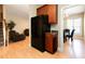 Modern kitchen with black refrigerator and ample cabinet space connects to the dining room and living area at 300 Sugar Maple Ave, Wake Forest, NC 27587