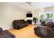 Comfortable living room features fireplace, TV and sliding doors to the back at 300 Sugar Maple Ave, Wake Forest, NC 27587
