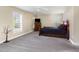 Spacious bedroom featuring a ceiling fan, neutral walls, carpet flooring, and two windows at 300 Sugar Maple Ave, Wake Forest, NC 27587