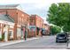 Charming street view featuring brick buildings and American flags at 300 Sugar Maple Ave, Wake Forest, NC 27587